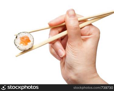 female hand with disposable chopsticks holds sake maki sushi roll with salmon fish isolated on white background