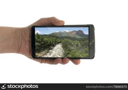 female hand with mobile phone isolated on white with drakensberg nature