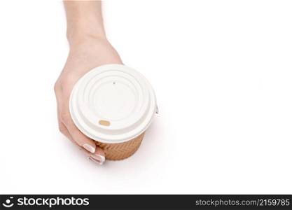 Female hand with paper cup of coffee isolated on white with clipping path.. Female hand with paper cup of coffee isolated on white with clipping path