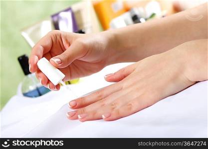 Female hands and manicure related objects in spa salon