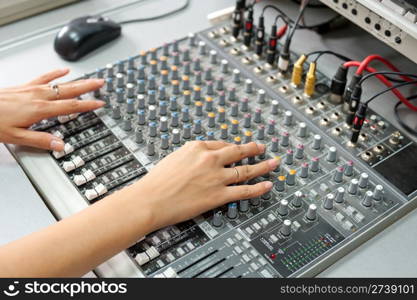 female hands at a sound mixing console