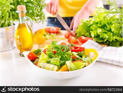 female hands cooking vegetable salad in kitchen