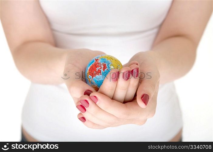 Female hands hold a small copy of globe on a white background
