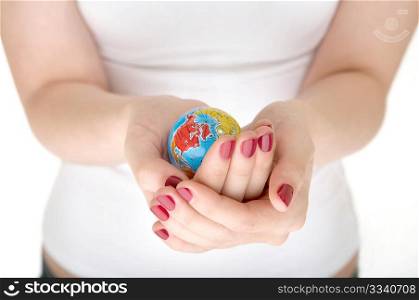 Female hands hold a small copy of globe on a white background