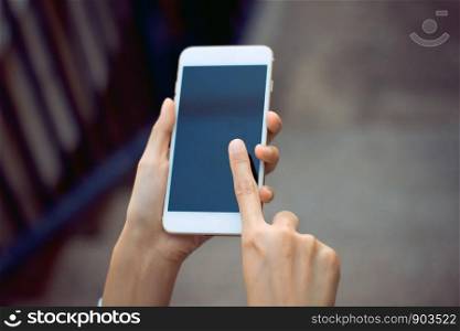 Female hands holding and using mobile phone with black screen
