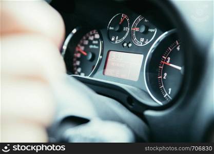 Female hands on a sports car steering wheel, car interior