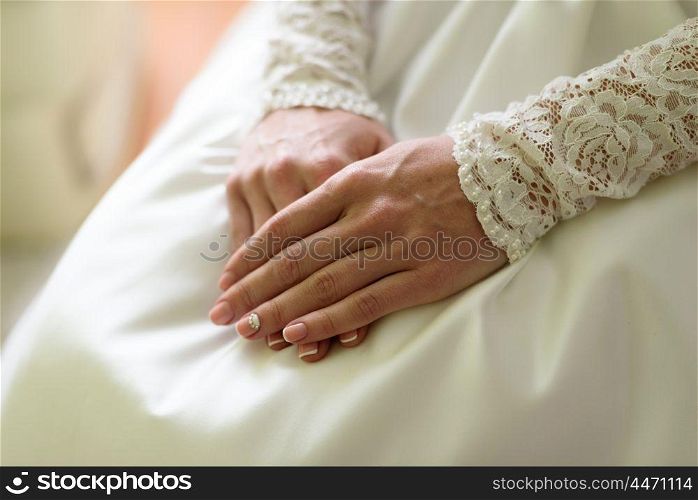 female hands on the wedding dress