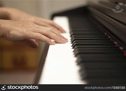 Female hands play the electric piano, Hand and piano keys close up