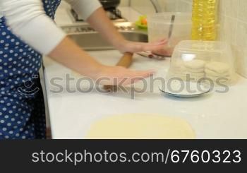 Female Hands Rolls Out Dough For Pies On Counter Top