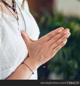 Female hands together close-up, gesture Namaste, Yoga, praying.