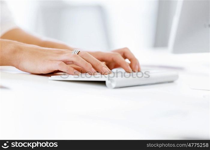 Female hands typing on the keyboard. Female hands typing on the white keyboard