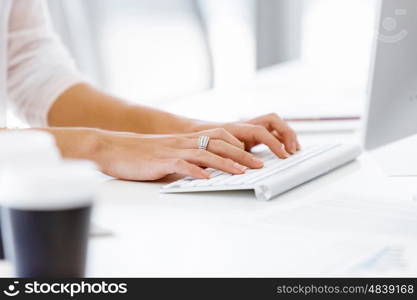 Female hands typing on the keyboard. Female hands typing on the white keyboard