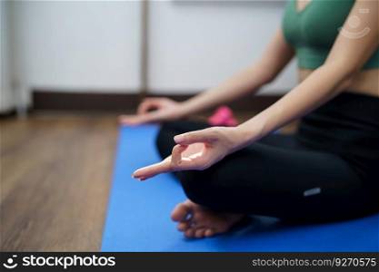 Female happiness Attractive young asian woman doing yoga stretching exercise on mat yoga & fitness exercises. Healthy lifestyle Calmness and relax at home
