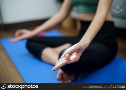 Female happiness Attractive young asian woman doing yoga stretching exercise on mat yoga   fitness exercises. Healthy lifestyle Calmness and relax at home 