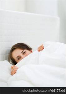 Female hiding behind blanket