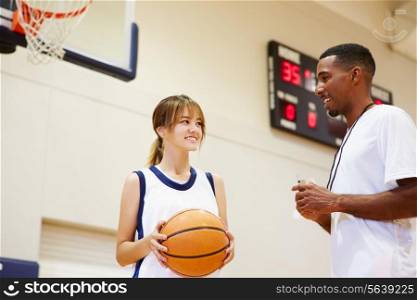 Female High School Basketball Player Talking With Coach