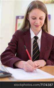 Female High School Pupil In Uniform Taking Multiple Choice Examination Paper