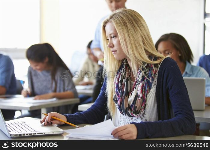 Female High School Student Using Laptop In Class