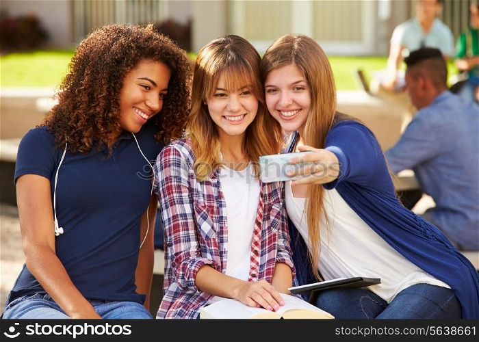 Female High School Students Taking Selfie On Campus