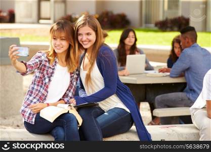 Female High School Students Taking Selfie On Campus
