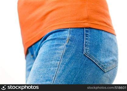 Female hips wearing blue tight slim jeans, on white. Clothing, fashion fit body concept.. Female hips wearing blue jeans