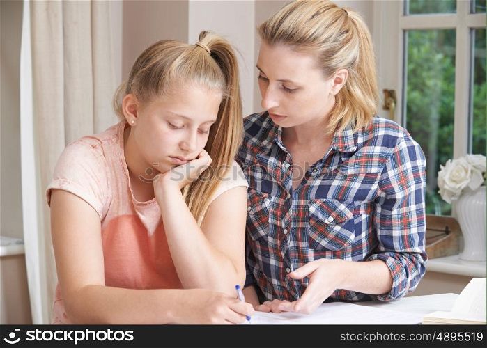 Female Home Tutor Helping Girl With Studies