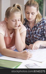 Female Home Tutor Helping Girl With Studies