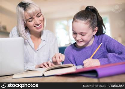 Female Home Tutor Helping Young Girl With Studies