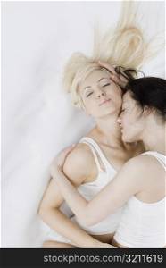 Female homosexual couple embracing each other on the bed