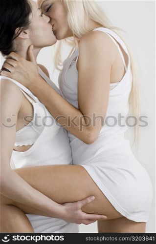 Female homosexual couple kissing each other