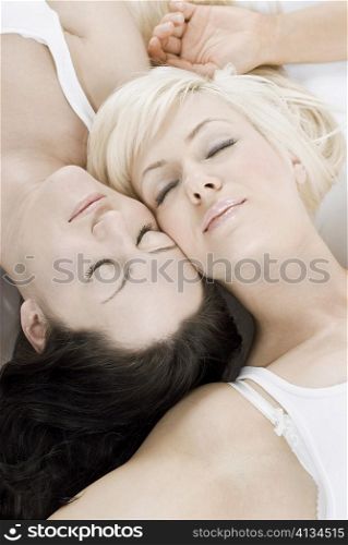 Female homosexual couple lying on the bed