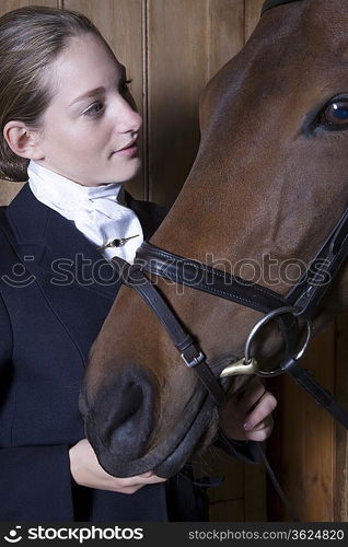 Female horseback rider with horse