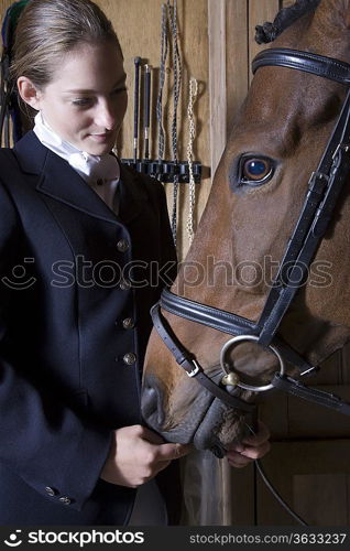 Female horseback rider with horse