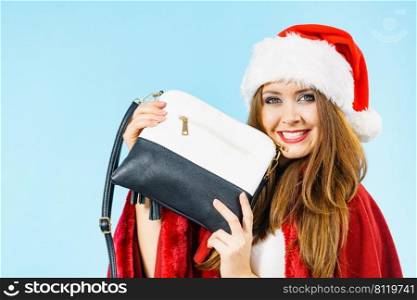 Female in santa claus clothing holding present handbag purse.. Christmas girl holding handbag present