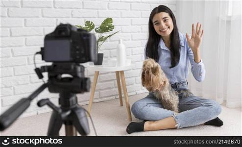 female influencer home vlogging with dog