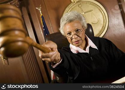 Female judge holding hammer in court