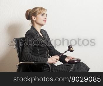 Female Judge With Wooden Gavel in office chair