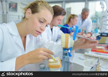 Female lab technician working on dentures