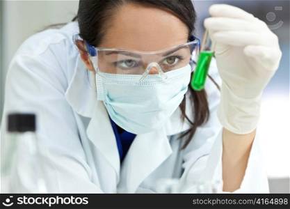 Female Laboratory Scientist or Doctor with Green Liquid Test Tube