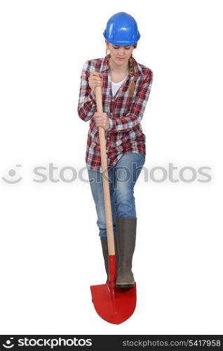 Female laborer digging with shovel