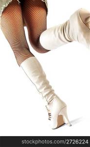 Female legs in stockings and white boots.
