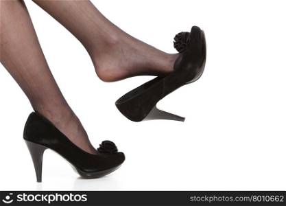 Female legs in tights and high heels. Part body of woman. Slim attractive gorgeous female legs in black pantyhose tights and high heels shoes isolated on white.