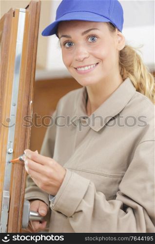female lock smith posing and smiling