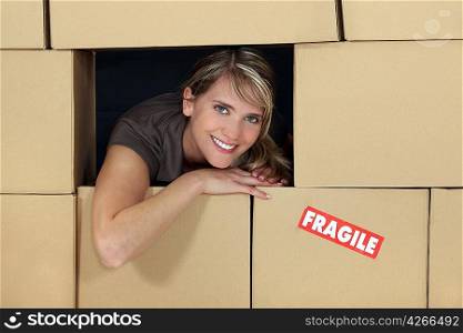 Female logistics manager surrounded by boxes