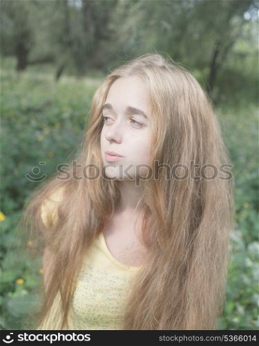 Female looking away. Pretty blonde outdoors. Colorized image