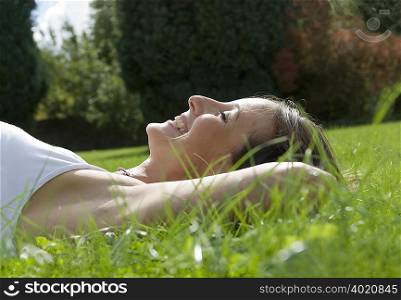 Female lying on grass smiling