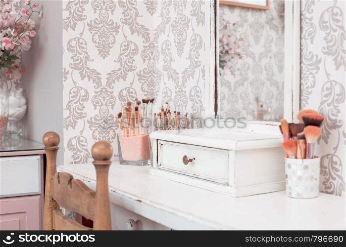 female makeup table with makeup including brushes and mirror. pink colors, girl design beauty and fashion. female makeup table with makeup including brushes and mirror. pink colors, girl design