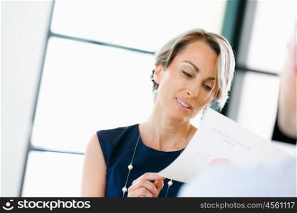 Female manager assessing work of her employees