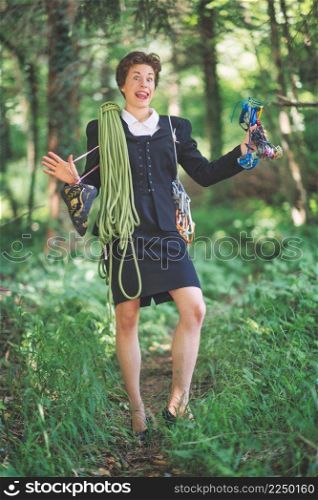 Female manager in taylor with rope and climbing equipment in a trail