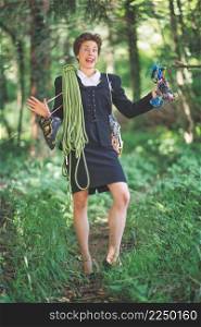 Female manager in taylor with rope and climbing equipment in a trail